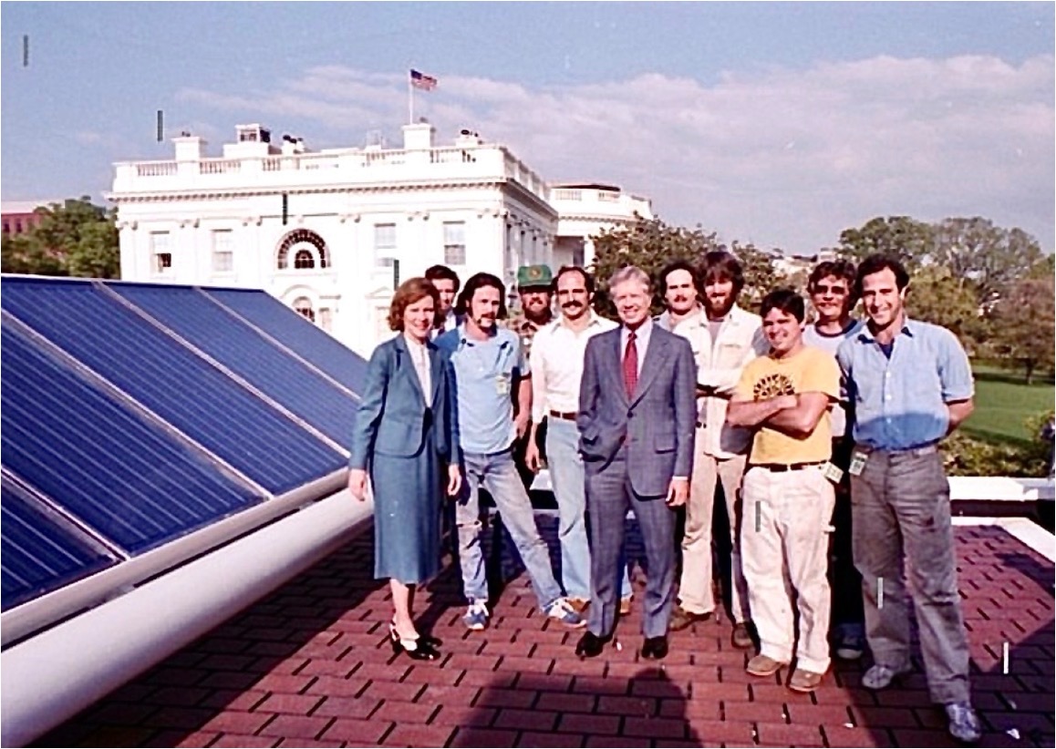 President Jimmy & Rosalynn Carter against a a backdrop of solar panels at the White House in 1979.